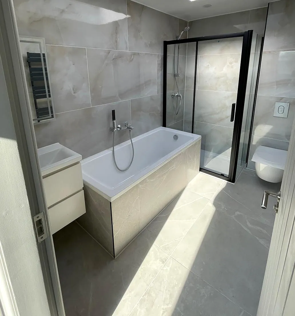 Bathroom with bath, shower enclosure and wall tiling