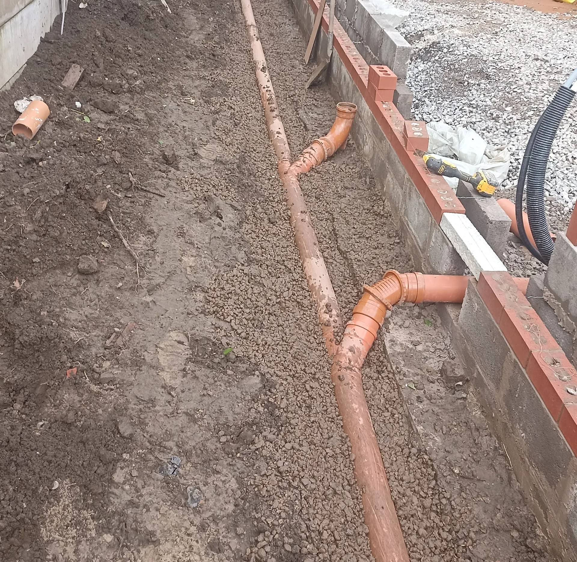 Below-ground drainage beside the developing extension