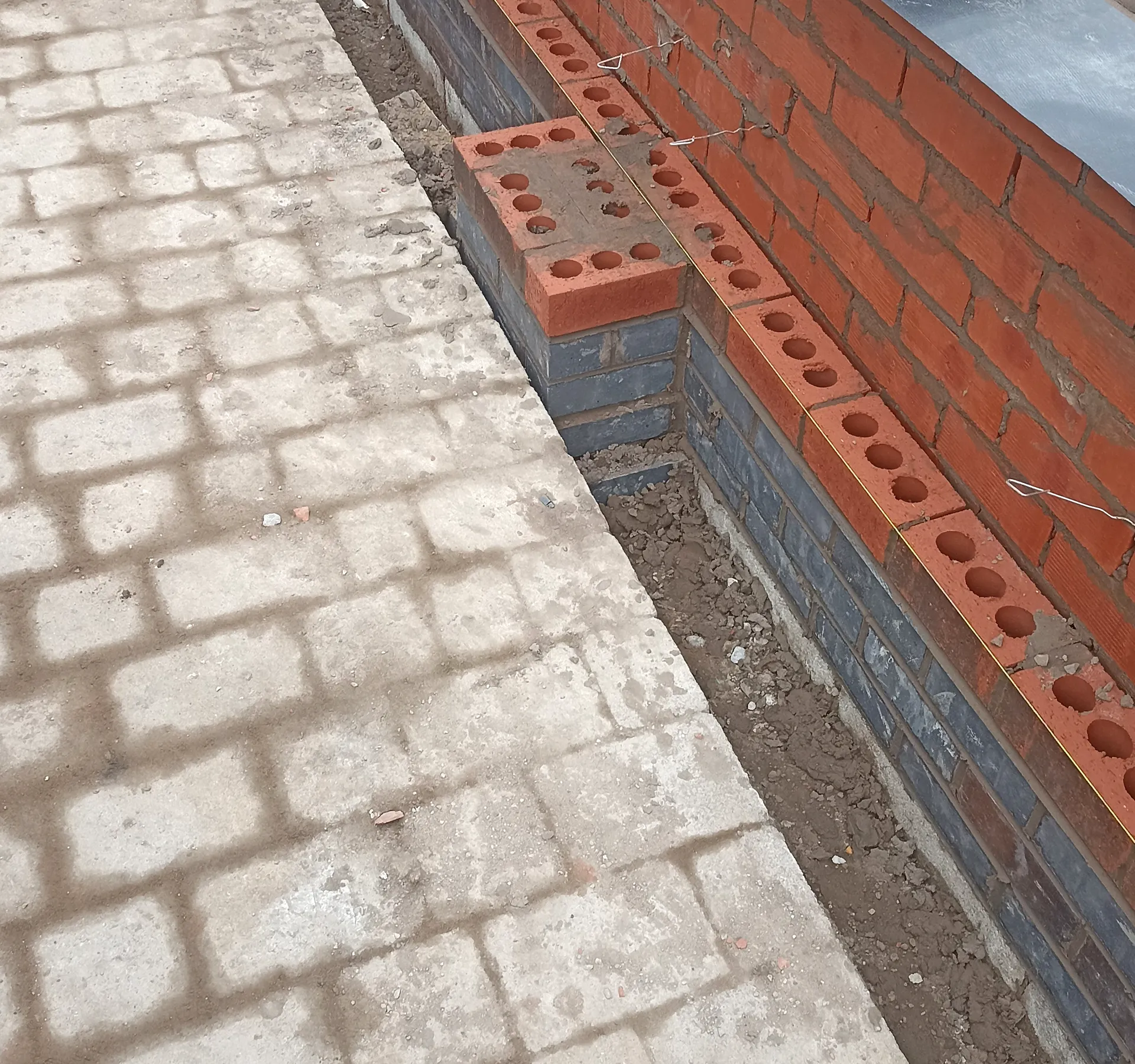 Paving installation beside brickwork