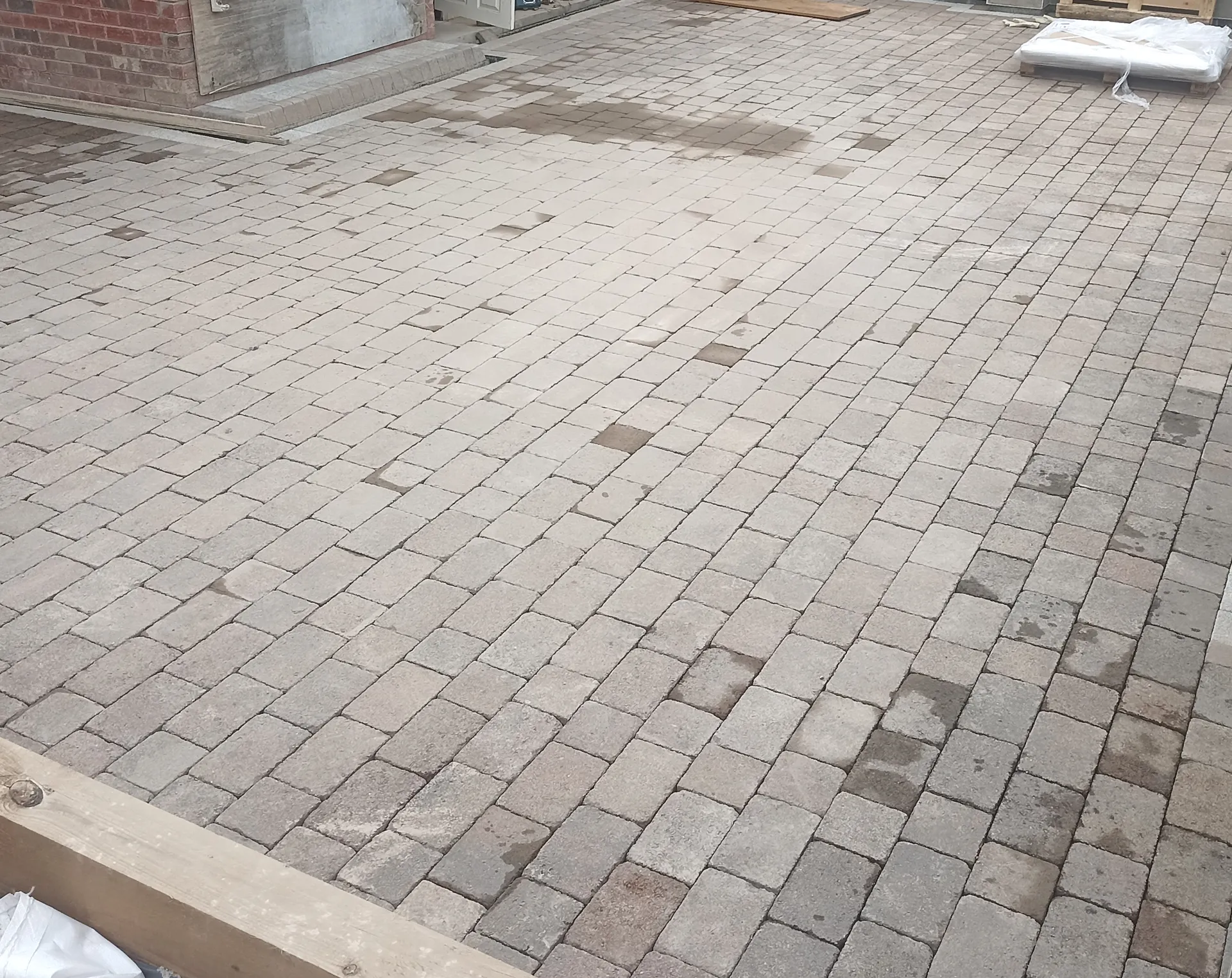 Block paving during the final driveway installation stages.