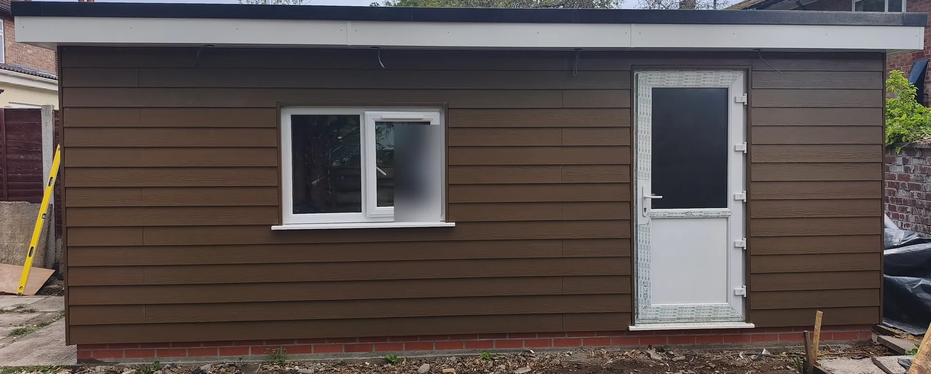 Garden room exterior with horizontal cladding, glazing and entrance door