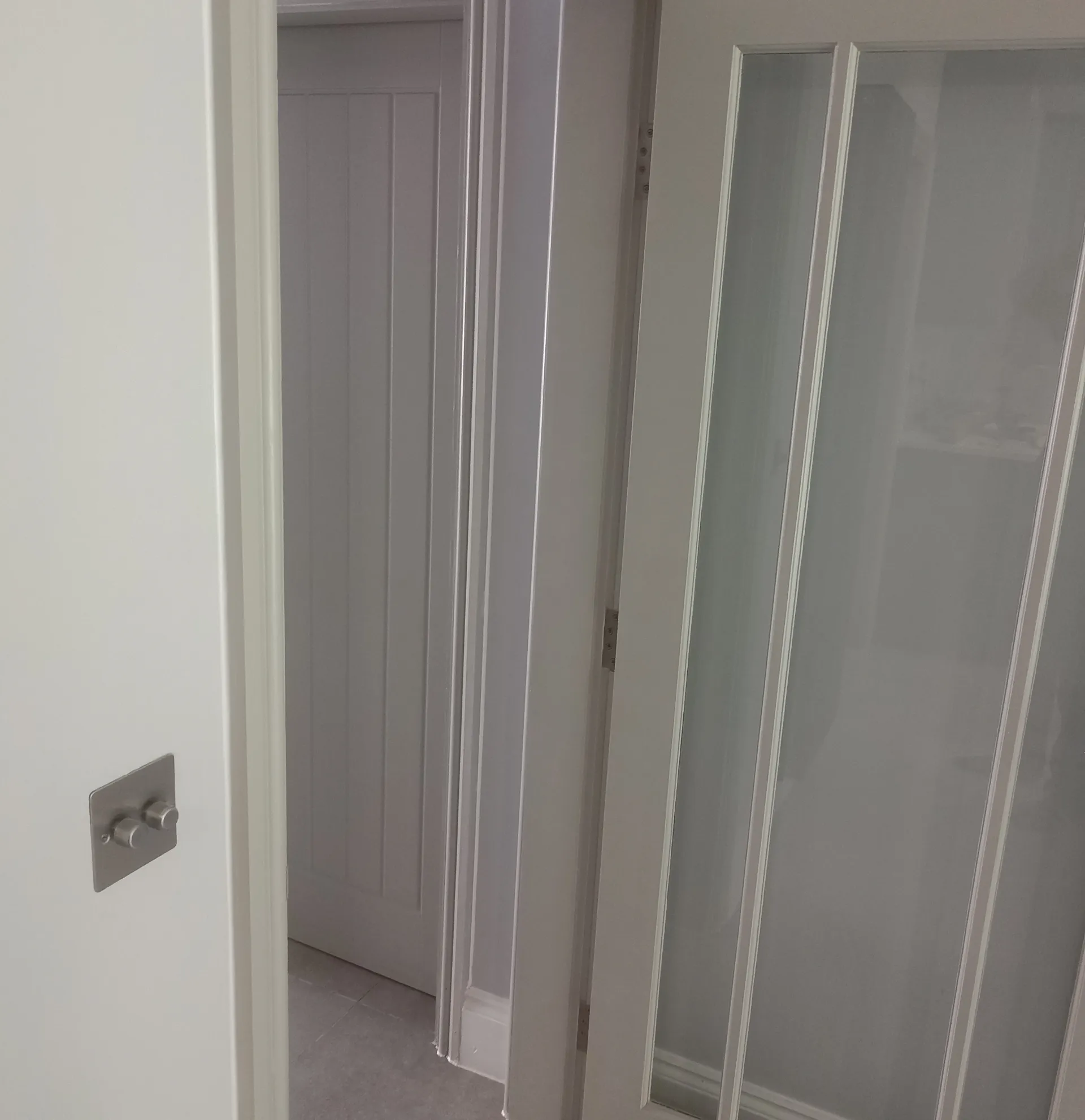 Painted internal architraves, skirting and panelled doors.