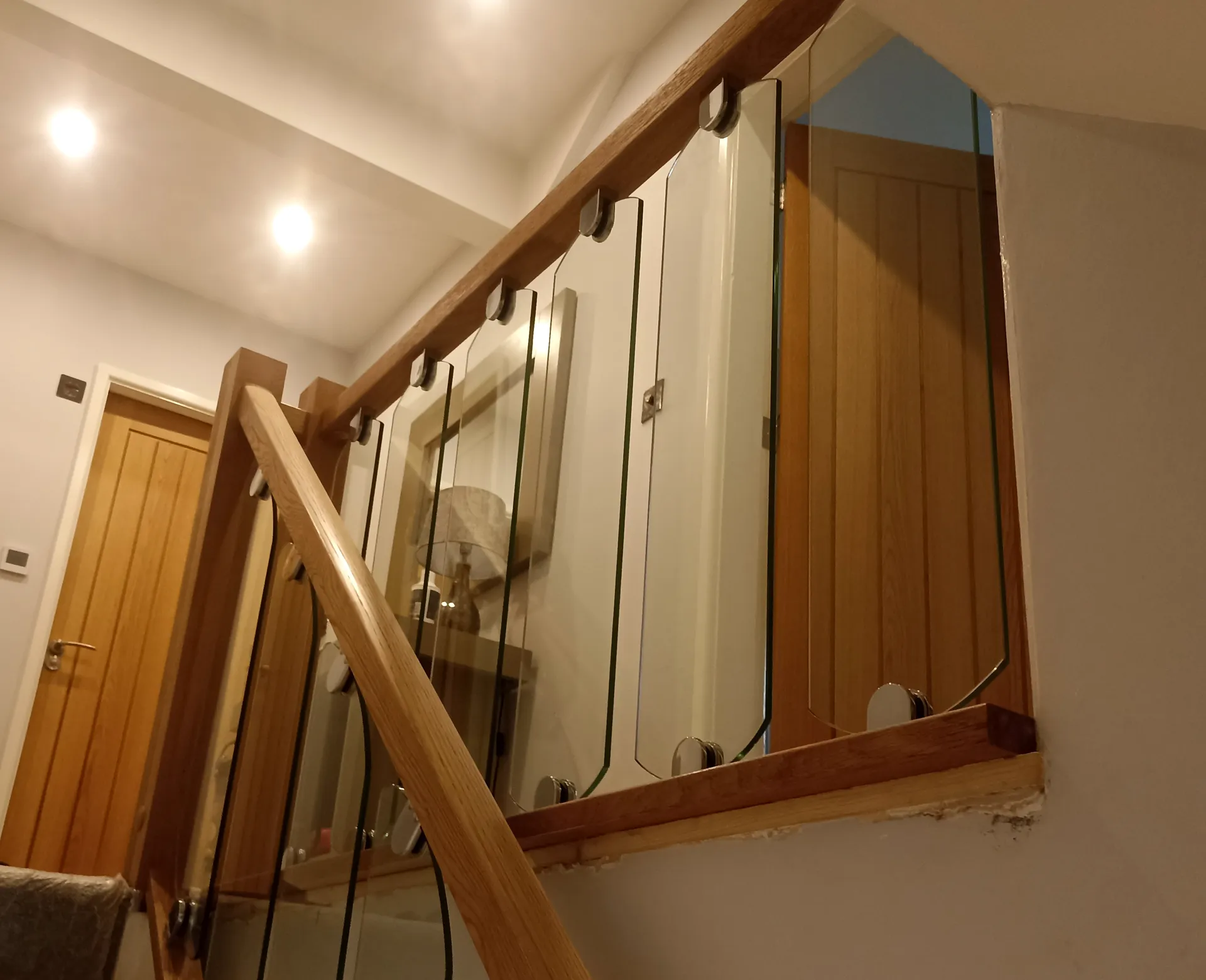 Timber handrails and glass balustrade at the staircase landing.