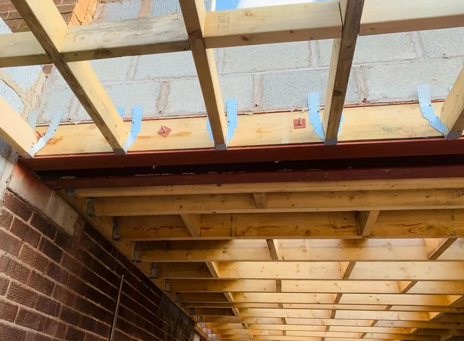Steel support, timber joists and metal hangers during structural alterations.
