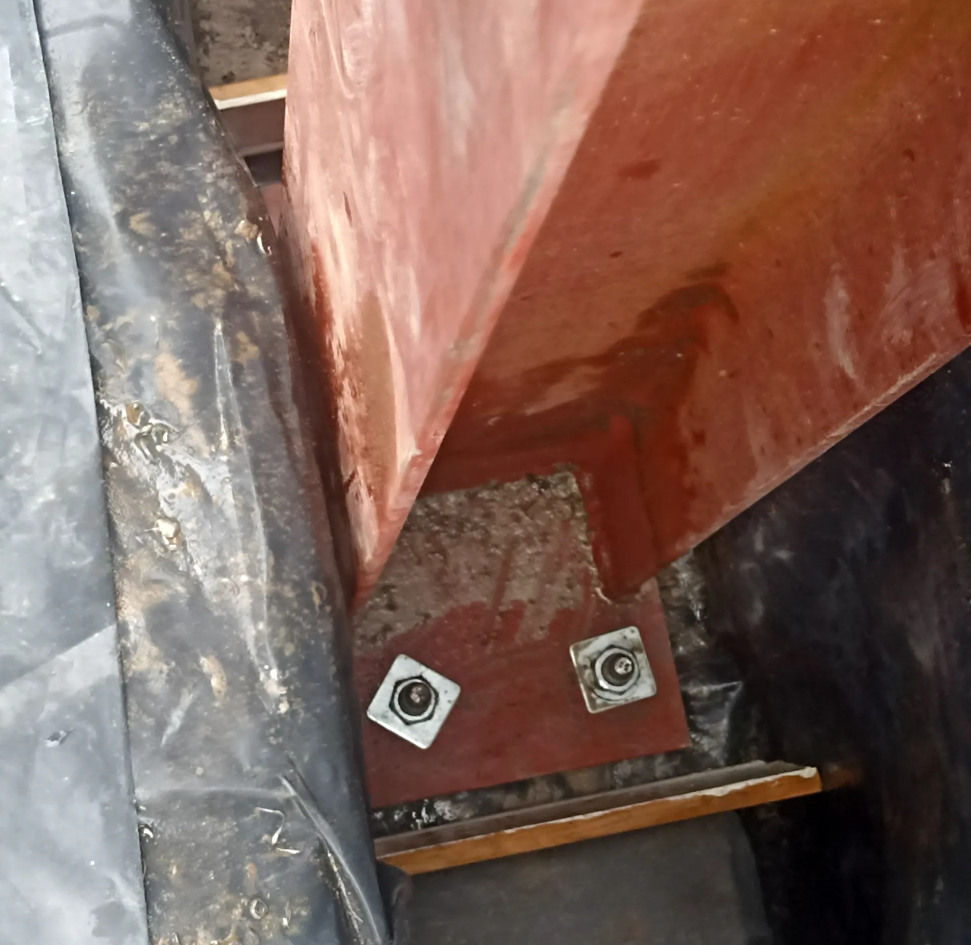 Bolted steel column base during structural installation.